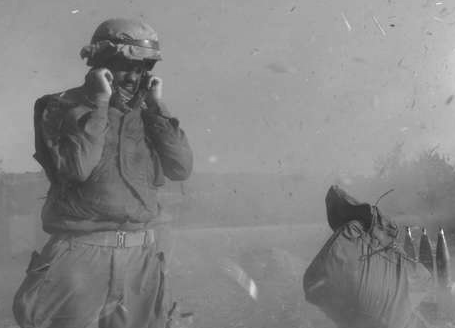 Historic photo of a soldier, who covers his ears