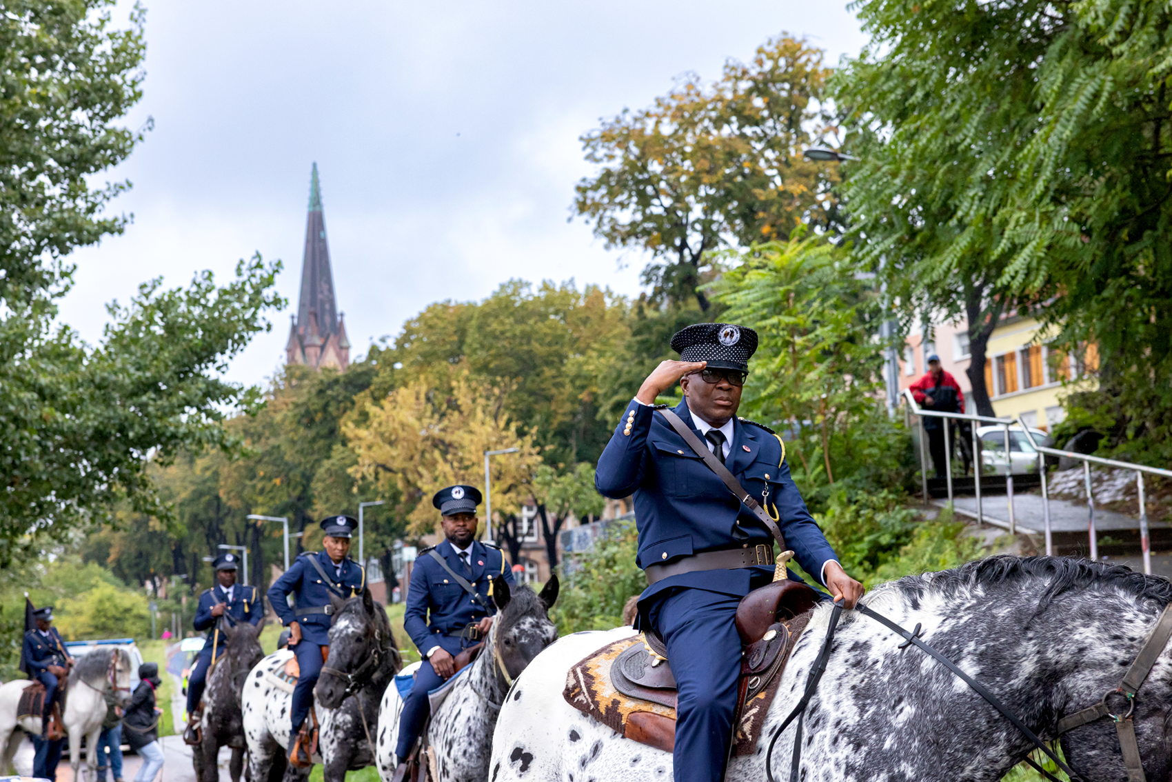 Personen in Militäruniformen reiten auf Pferden entlang der Neckarwiese